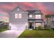 Charming two-story home with a well-manicured lawn and integrated two car garage at 102 Bolsena Ct, Summerville, SC 29486