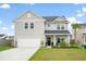 Charming two-story home with a well-manicured lawn and integrated two car garage at 102 Bolsena Ct, Summerville, SC 29486
