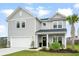 Charming two-story home with a well-manicured lawn and integrated two car garage at 102 Bolsena Ct, Summerville, SC 29486