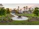 Outdoor community fire pit with a picnic area surrounded by trees, greenery and neighborhood homes at 102 Bolsena Ct, Summerville, SC 29486
