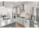 Bright kitchen boasts stainless steel appliances, gray countertops, and ample cabinet space at 102 Bolsena Ct, Summerville, SC 29486