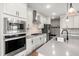 Well-equipped kitchen with stainless steel appliances, white cabinets, and center island at 102 Bolsena Ct, Summerville, SC 29486
