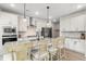 Modern kitchen with white cabinets, stainless steel appliances, and a spacious island with barstools at 102 Bolsena Ct, Summerville, SC 29486