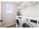 Bright laundry room features a modern washer and dryer, ample storage, and a window at 102 Bolsena Ct, Summerville, SC 29486