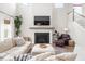Well-lit living room with fireplace, sectional couch, and oversized chair, creating a welcoming atmosphere at 102 Bolsena Ct, Summerville, SC 29486