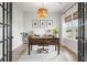 Inviting home office with rustic wood desk, charming light fixture, and an abundance of natural light at 102 Bolsena Ct, Summerville, SC 29486