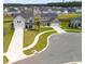 Street view of two-story homes with well-manicured lawns and landscaping on a cul-de-sac at 102 Bolsena Ct, Summerville, SC 29486