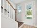 Entryway with stairs features a glass front door and wood railing with white risers at 102 Hawthorne Landing Dr, Goose Creek, SC 29445