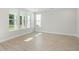 Bright living room with large windows providing natural light and wood-look floors at 102 Hawthorne Landing Dr, Goose Creek, SC 29445