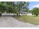 Charming single-story home with white exterior, dark shutters, and spacious gravel driveway at 105 Evatt Dr, Goose Creek, SC 29445