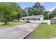 Beautiful white house with black shutters, a concrete driveway, and a manicured lawn at 105 Evatt Dr, Goose Creek, SC 29445
