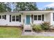 Close-up of charming home's entrance featuring a vibrant blue front door and white brick facade at 105 Evatt Dr, Goose Creek, SC 29445