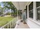 Charming front porch with white railing, brick wall, and decorative greenery at 105 Evatt Dr, Goose Creek, SC 29445
