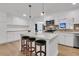 Bright kitchen with white cabinets, stainless steel appliances, a brick backsplash, and hardwood floors at 105 Evatt Dr, Goose Creek, SC 29445