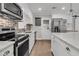 Well-equipped kitchen with stainless steel appliances, white cabinets, and a brick backsplash at 105 Evatt Dr, Goose Creek, SC 29445