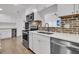 Modern kitchen featuring stainless steel appliances, quartz countertops, and a stylish brick backsplash at 105 Evatt Dr, Goose Creek, SC 29445