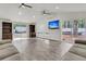 Open-concept living room with vaulted ceilings, wood paneling, and sliding glass door at 105 Evatt Dr, Goose Creek, SC 29445