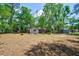 Wide backyard featuring mature trees, ample space, and natural surroundings, perfect for outdoor activities at 106 Kent Cir, Ladson, SC 29456