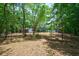 Expansive backyard with tall trees, a weathered fence, and lush greenery, providing a tranquil setting at 106 Kent Cir, Ladson, SC 29456