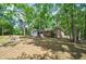 Backyard with mature trees and a structure creating a serene and private outdoor space at 106 Kent Cir, Ladson, SC 29456