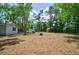 Expansive backyard featuring a shed and surrounded by mature trees, offering privacy and a park-like setting at 106 Kent Cir, Ladson, SC 29456