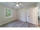 Bright bedroom with light colored floors, a window, ceiling fan, and double-door closet at 106 Kent Cir, Ladson, SC 29456