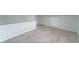 Spacious bonus room with neutral carpet, white trim, and a staircase providing a versatile area at 106 Kent Cir, Ladson, SC 29456