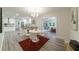 Bright dining area adjacent to kitchen features a round table, modern chairs, and a colorful rug at 106 Kent Cir, Ladson, SC 29456