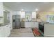Well-lit kitchen with granite countertops, stainless steel appliances, and ample cabinet space at 106 Kent Cir, Ladson, SC 29456