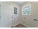 Functional laundry area with a white door, ample outlets, and a window for natural light at 106 Kent Cir, Ladson, SC 29456