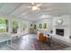 Bright living room with fireplace, ceiling fan, large windows, and light-colored floors at 106 Kent Cir, Ladson, SC 29456