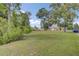 A spacious backyard with a large grassy area, offering plenty of room for outdoor activities and recreation at 108 Mourning Dove Dr, Bonneau, SC 29431