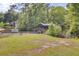 A scenic backyard features a covered dock on the water and lush green grass, perfect for outdoor enjoyment at 108 Mourning Dove Dr, Bonneau, SC 29431