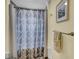 Cozy bathroom showcasing a patterned shower curtain, towel rack, and framed artwork at 108 Mourning Dove Dr, Bonneau, SC 29431