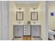 Bathroom featuring dual vanities with gray cabinets, a central drawer unit, and neutral decor at 108 Mourning Dove Dr, Bonneau, SC 29431