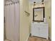 Cozy bathroom with shower and white vanity, decorated with lake themed decor at 108 Mourning Dove Dr, Bonneau, SC 29431