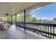 Inviting deck with dark wood and overlooking green trees and a pond at 108 Mourning Dove Dr, Bonneau, SC 29431