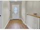 The entryway showcases a wood floor, a decorative door, and white banisters, blending style and functionality at 108 Mourning Dove Dr, Bonneau, SC 29431