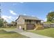 The side view reveals a home with a brick foundation, and a metal roof, complemented by a spacious driveway and lush lawn at 108 Mourning Dove Dr, Bonneau, SC 29431