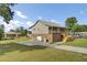 The side view highlights a brick foundation, a metal roof, a spacious driveway, and an expansive lawn, showcasing outdoor living at 108 Mourning Dove Dr, Bonneau, SC 29431