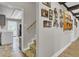 Charming hallway leading to the kitchen with photographs and a wooden shelf on the wall at 108 Mourning Dove Dr, Bonneau, SC 29431