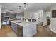 Open-concept kitchen with gray cabinets, a stainless steel dishwasher, and modern fixtures at 108 Mourning Dove Dr, Bonneau, SC 29431