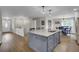 Open floor plan showcasing kitchen island with breakfast bar with stainless steel appliances at 108 Mourning Dove Dr, Bonneau, SC 29431