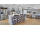Open concept kitchen with island and stainless steel appliances flows into cozy living room with fireplace at 108 Mourning Dove Dr, Bonneau, SC 29431