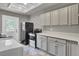 Well-equipped laundry room with cabinets, appliances and a convenient door to the outside at 108 Mourning Dove Dr, Bonneau, SC 29431