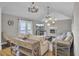 Cozy living room with vaulted ceilings, a fireplace, and double french doors to outdoor space at 108 Mourning Dove Dr, Bonneau, SC 29431