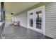 Spacious outdoor porch with comfortable seating and a view of trees at 108 Mourning Dove Dr, Bonneau, SC 29431