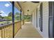Inviting outdoor porch with wooden railings, ceiling fans, and black window shutters, perfect for relaxing and enjoying the view at 108 Mourning Dove Dr, Bonneau, SC 29431