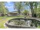 Spacious backyard featuring an oversized pond and surrounded by trees at 108 Williamsburg Ct, Goose Creek, SC 29445