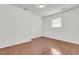 Empty basement offers hardwood floors, white walls, and a single window providing natural light at 108 Williamsburg Ct, Goose Creek, SC 29445
